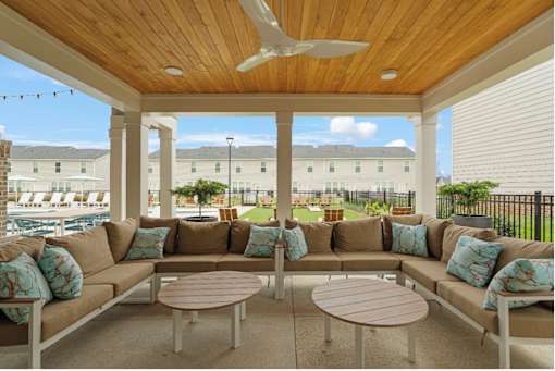 A patio with a sofa set and a table.