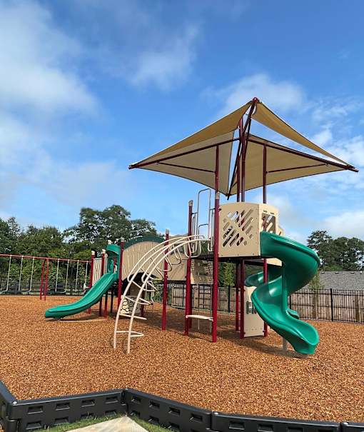 a playground with a slide and monkey bars
