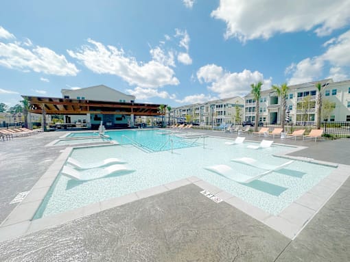 A large swimming pool with a building in the background.