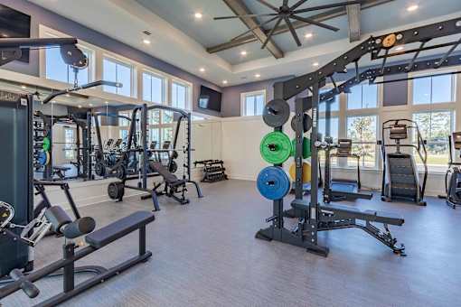 A spacious home gym with a variety of exercise equipment.