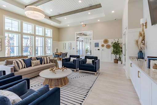 A living room with a blue couch and a white coffee table.