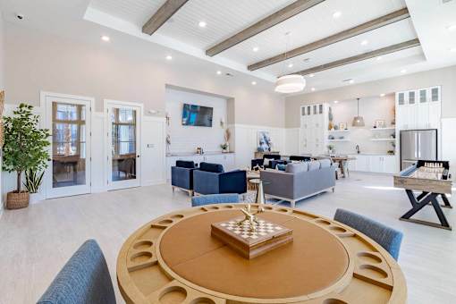 A modern living room with a wooden coffee table in the center.