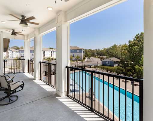 take in the view of the pool from the balcony of your home