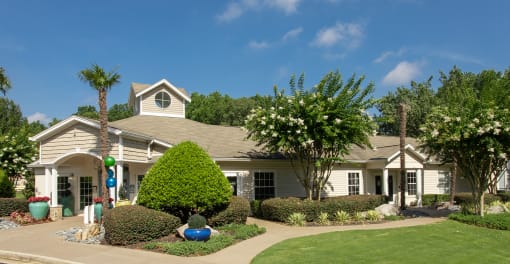 a house with a lawn and trees in front of it