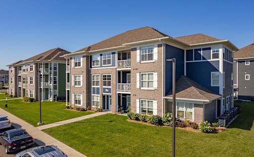 A row of townhouses with a clear blue sky above them.