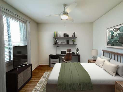 A bedroom with a bed, desk, and chair.