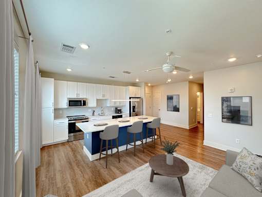 A modern kitchen with a dining table and chairs.