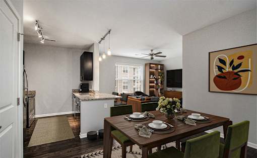 A dining room with a table set for a meal.