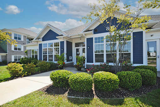 A row of houses with blue trim and white siding.