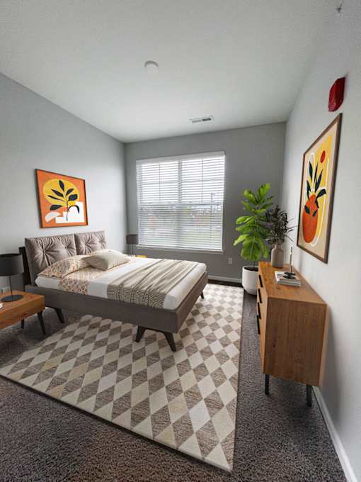 A bedroom with a bed, nightstand, and a plant.