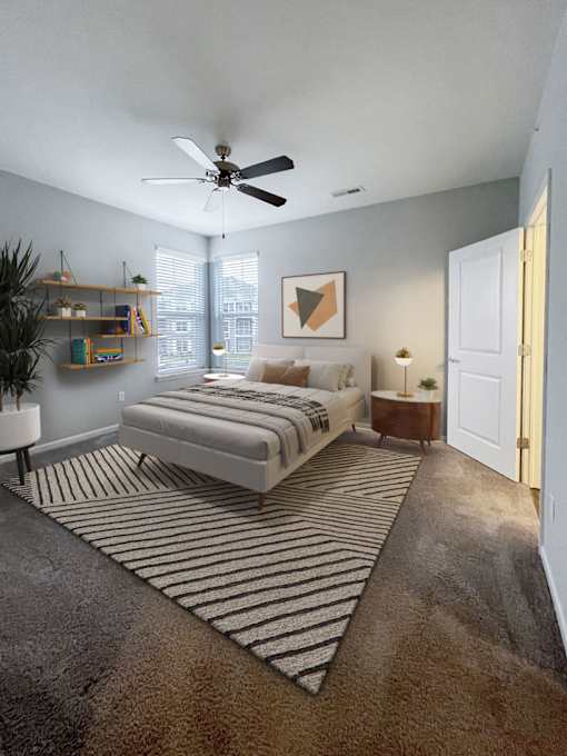 A bedroom with a bed, a ceiling fan, and a rug.