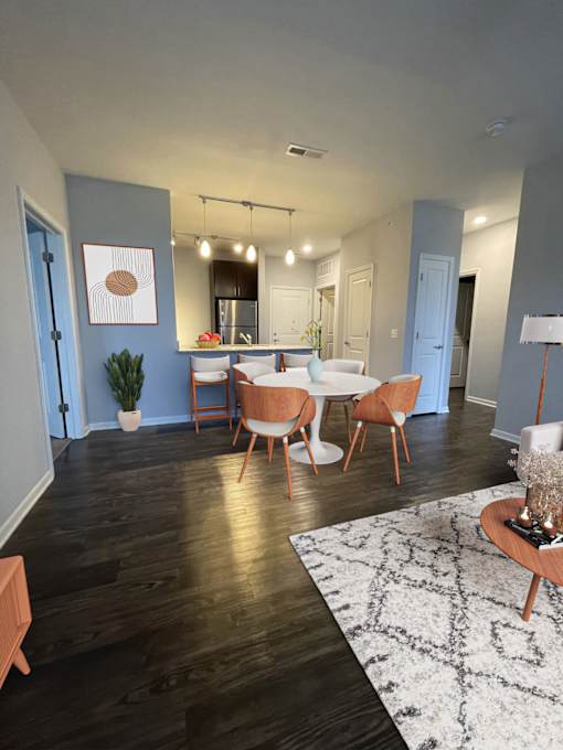 A dining room with a table set for four.