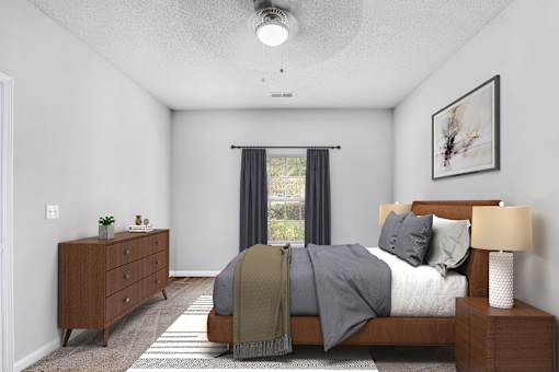 A bedroom with a bed, nightstand, and window with curtains.