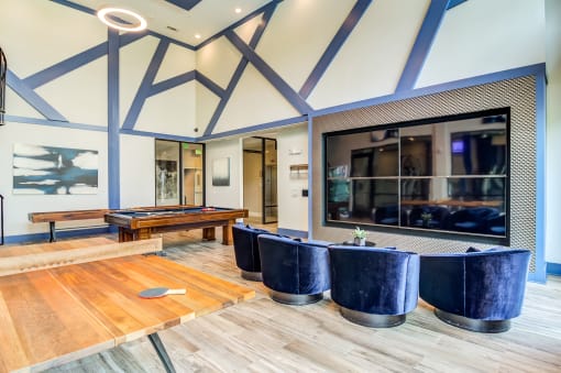 a large room with a pool table and a large mirror