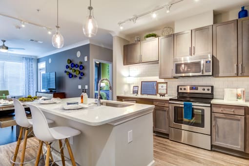 a kitchen with stainless steel appliances and a white counter top