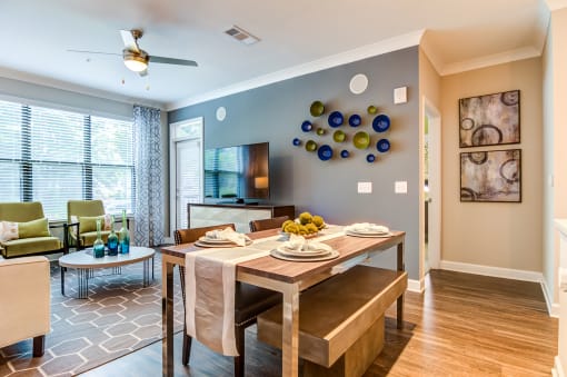 a living room with a dining room table and a television