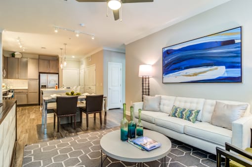 a living room and dining room area with a couch and a table