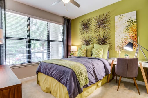 a bedroom with a bed and a desk with a chair