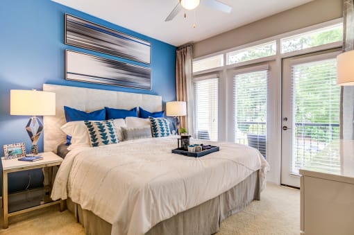 a bedroom with a large bed and a large window