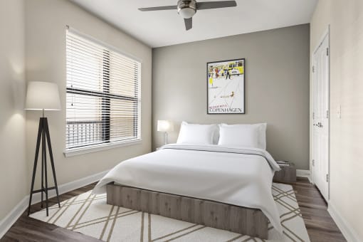 1 Bedroom Luxury Apartments in Decatur, GA - Reserve Decatur - Bedroom With Designer Plank Flooring, Modern Ceiling Fan, Window With Vertical Blinds, Wall Art, and Floor Lamp. 