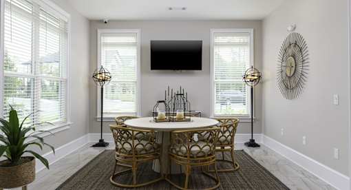 A dining room with a round table and chairs.