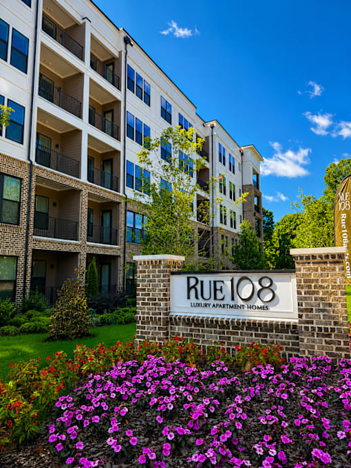 A building with the sign Rue 108 in front of it.