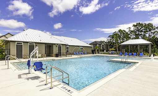 A pool with a metal railing and a sign that says "VETERANS" on the side.