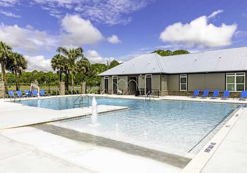 A pool with a fountain in the middle of it.