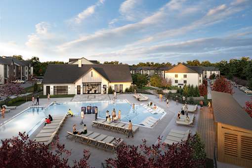A group of people are gathered around a pool in a resort.