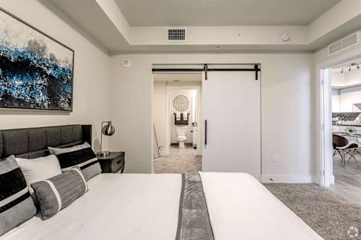 A bedroom with a large bed and a painting on the wall at Saba Pompano Beach, Pompano Beach, 33062