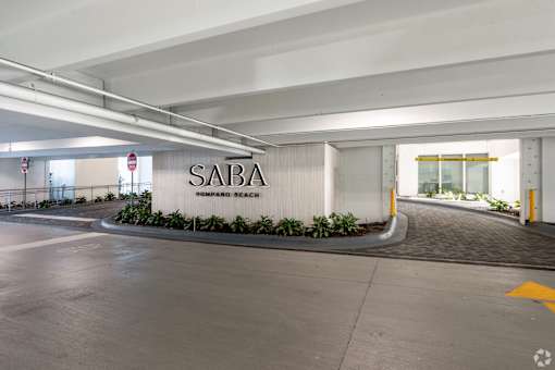 A parking garage with a sign that says SABA at Saba Pompano Beach, Pompano Beach, 33062