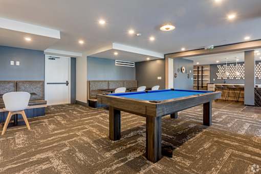 A room with a pool table and a chair at Saba Pompano Beach, Pompano Beach, 33062