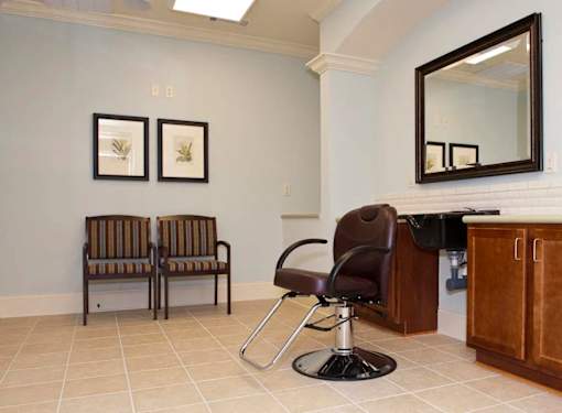 Two chairs with striped cushions sit in a waiting area.
