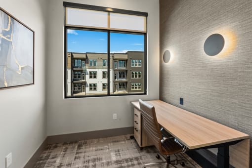 a conference room with a window and a desk and chairs