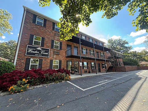 A building with a sign that says "Woodlawn Court" is shown.