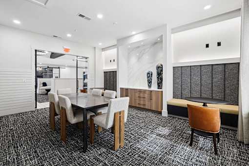 A conference room with a long table and chairs.