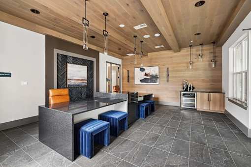 A modern kitchen with a wooden ceiling and a grey floor.