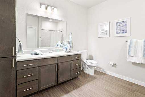 A bathroom with a white sink and a white toilet.