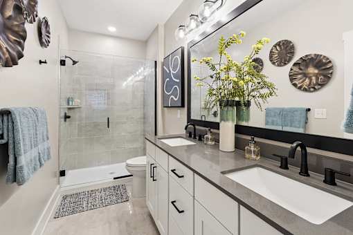 A bathroom with a white toilet, a sink, and a mirror.