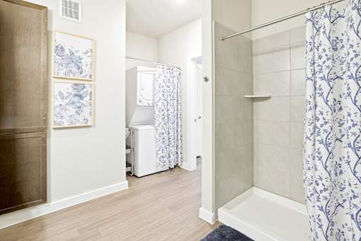 A bathroom with a white and blue shower curtain.