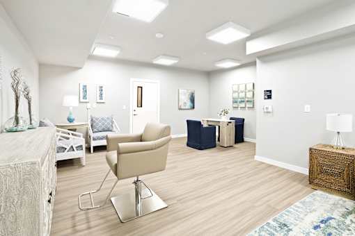 A living room with a beige chair and a white couch.