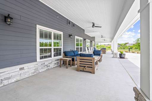 A patio with a white ceiling and a stone wall.