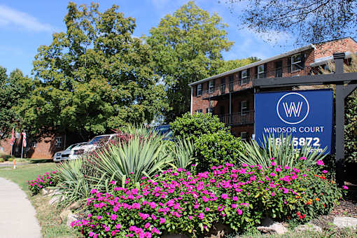 A sign for Windsor Court is in front of a building.
