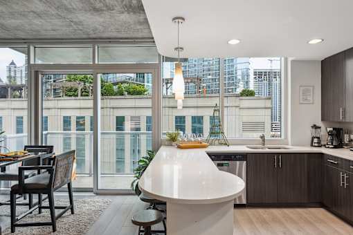 A modern kitchen with a dining table and chairs.