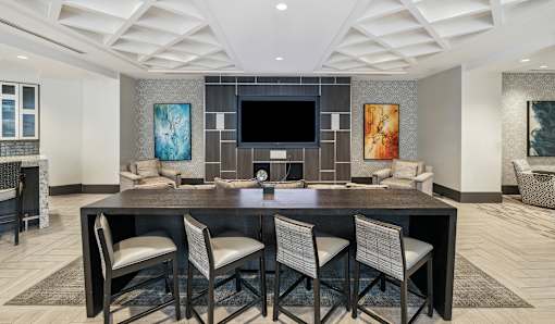 A modern dining room with a large table and chairs.