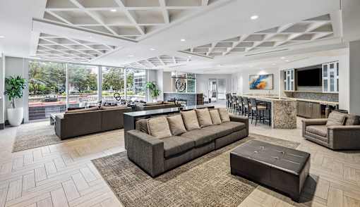 A spacious living room with a large sectional sofa and a coffee table.