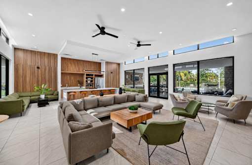 A modern living room with a large sectional sofa and a coffee table.