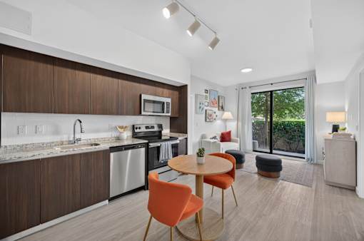 A modern kitchen with a dining table and chairs.