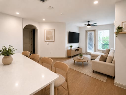 A living room with a white table and chairs.