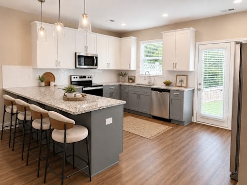 A spacious kitchen with marble countertops and bar top sitting